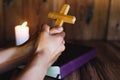 Hand holding the cross on the Bible and praying for the blessing of God with faith in His power, the idea of Ã¢â¬â¹Ã¢â¬â¹faith in the Royalty Free Stock Photo